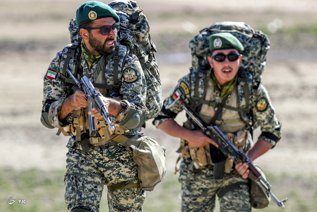 Iranian armed troops stand in formation during a military exercise, reflecting the country's ongoing emphasis on national defense and security preparedness.