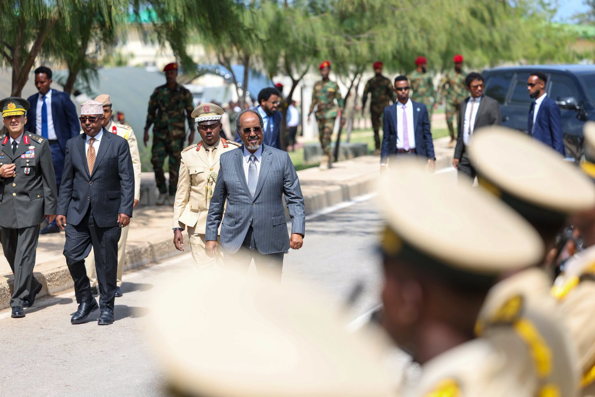 Somali President Hassan Sheikh Mohamud arrives at the graduation ceremony for newly commissioned Somali National Army officers and deputy officers at the TURKSOM Military Training Academy in Mogadishu, where he presided over the event and congratulated the graduates on completing their military training.