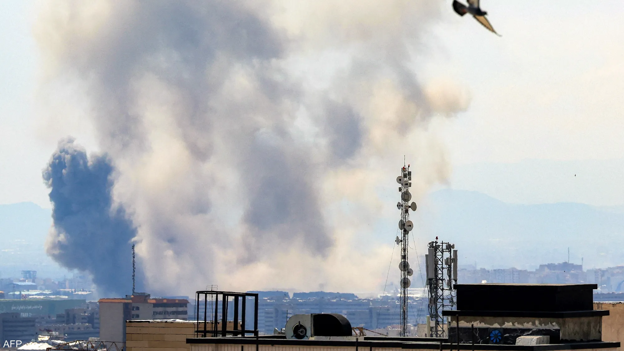 Smoke rises over Tehran following reported military strikes.