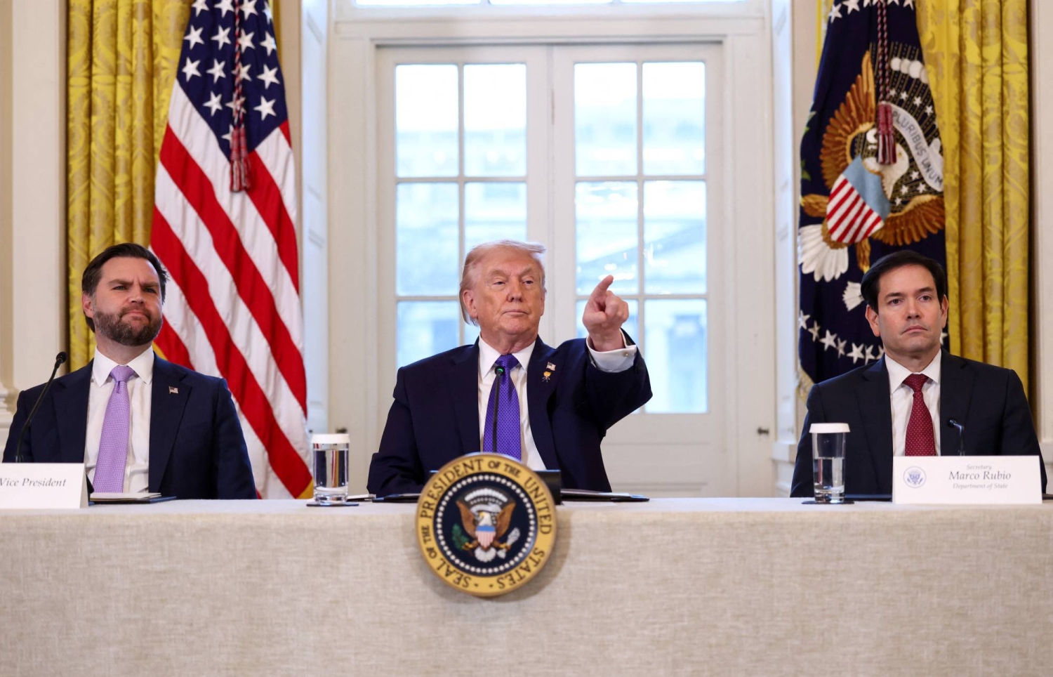 U.S. President Donald Trump takes questions from reporters while Vice President JD Vance and Secretary of State Marco Rubio look on, as they attend a meeting with oil industry executives at the White House in Washington in January. | REUTERS