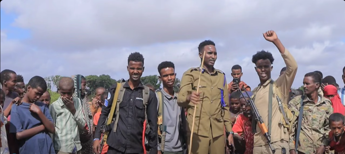 Hirshabelle State Police officers raise their hands in a sign of victory following a security operation in Mahadaay district, Middle Shabelle region.