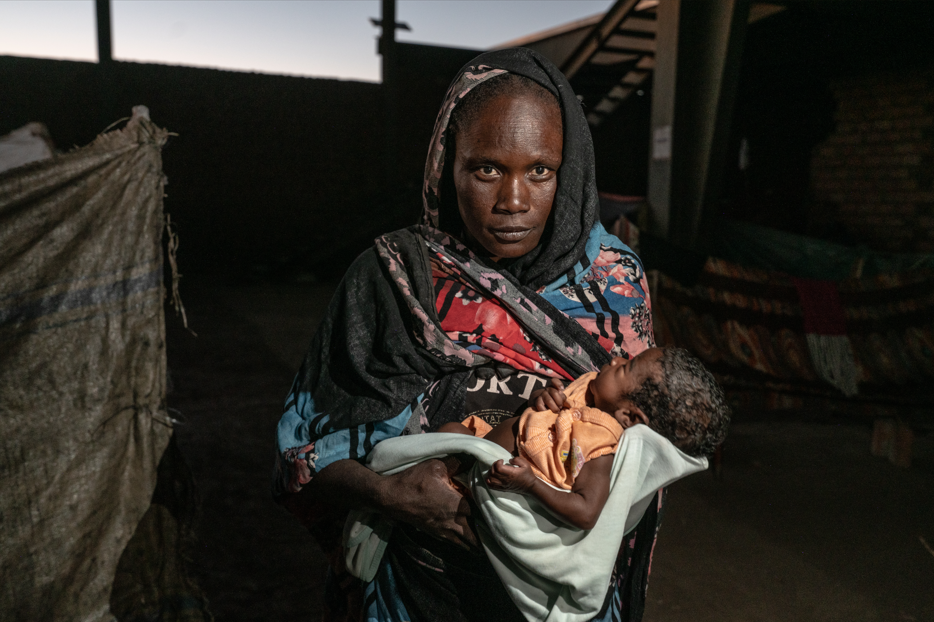 Displaced Sudanese families gather at a temporary shelter in Khartoum as the UN warns that nearly 70 percent of the population now lives in poverty amid the ongoing conflict between the army and RSF.