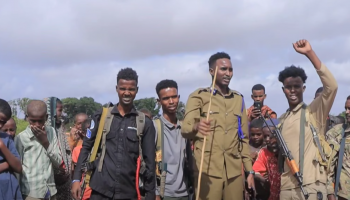 Hirshabelle State Police officers raise their hands in a sign of victory following a security operation in Mahadaay district, Middle Shabelle region.