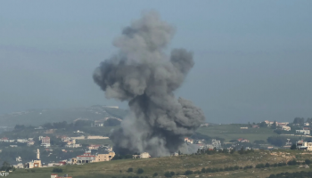 Fire and thick smoke rise from heavily destroyed buildings in Lebanon following Israeli airstrikes, shellings, and reported killings, leaving widespread destruction across the surrounding area.